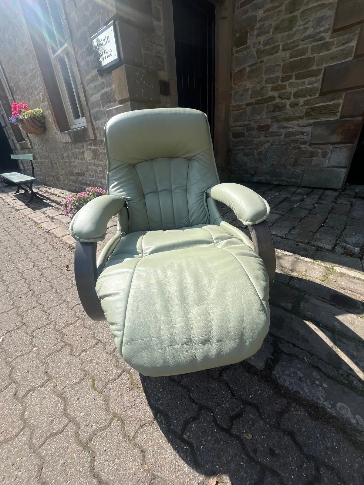 Grey leather swivel recliner with matching footstool